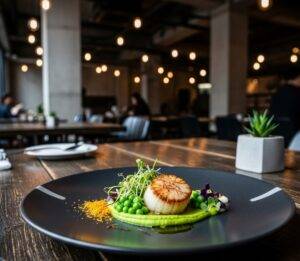 A beautifully plated gourmet dish on a dark, rustic table, illuminated by the soft, ambient light of a trendy, industrial-chic restaurant in Seongsu-dong.