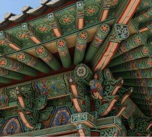 The intricate and colorful 'dancheong' painted eaves of the main Dharma Hall at Bongeunsa Temple in Seoul.
