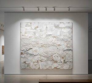 Curated Walking Tour: A large, textured monochrome abstract painting, reminiscent of the Korean Dansaekhwa movement, in a modern gallery.