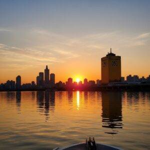 A breathtaking golden hour view of the 63 Building and Yeouido skyline in Seoul, taken from a boat on the Han River during the Sunset Cruise.