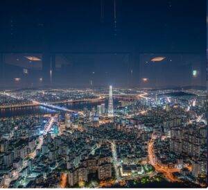 A stunning panoramic night view of the massive, sparkling cityscape of Seoul as seen from the high observatory of the N Seoul Tower, with endless city lights.