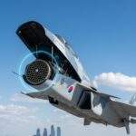 KF-21 Boramae fighter jet flying over Seoul with its nose cone open, revealing a glowing, advanced AESA radar array.