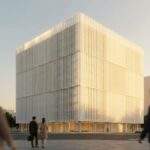 A wide-angle landscape view of the Amorepacific Headquarters building in Yongsan, Seoul, glowing during golden hour with blurred people walking in the foreground.