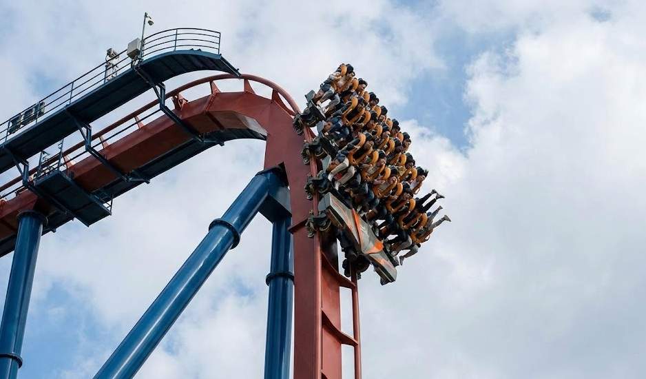 The Draken dive coaster at Gyeongju World amusement park hanging vertically at a 90-degree angle just before the main drop.