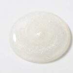 VT Reedle Shot Review: Close-up macro photography of VT Reedle Shot serum droplet showing pearlescent texture with suspended micro-spicules.