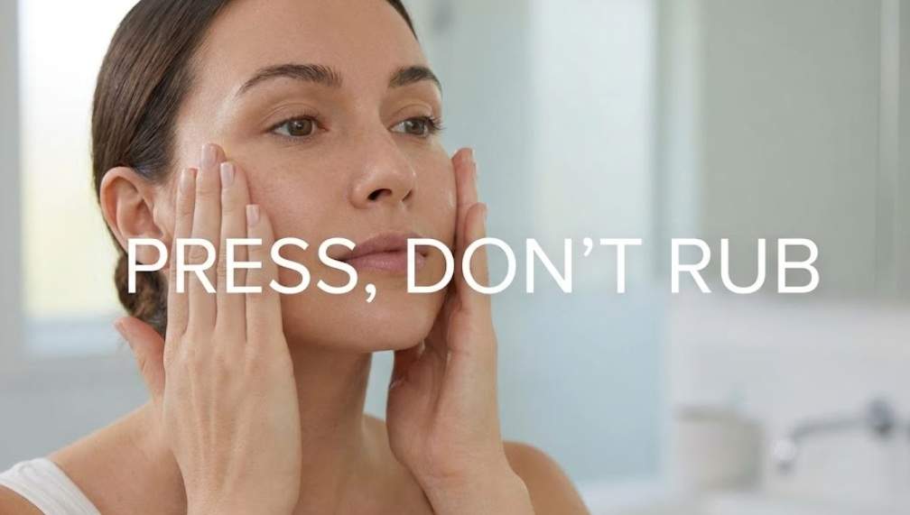 VT Reedle Shot Pain: A woman pressing skincare into her face with text overlay "PRESS, DON'T RUB".