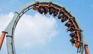 Gyeongju World Thrill Guide: The Phaethon inverted roller coaster at Gyeongju World speeding upside down through a loop track against a blue sky.