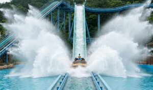 A boat plunging into the water pool on the Submarine Splash flume ride at Gyeongju World, creating a gigantic wave of water.