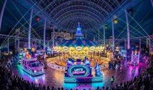 The night parade inside Lotte World's indoor dome, featuring neon lights and laser beams.