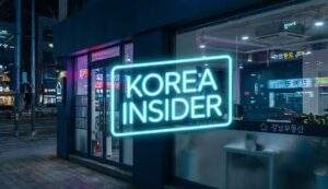 A night photograph of a modern real estate office in Gangnam with a neon sign reading "KOREA INSIDER" in the window.